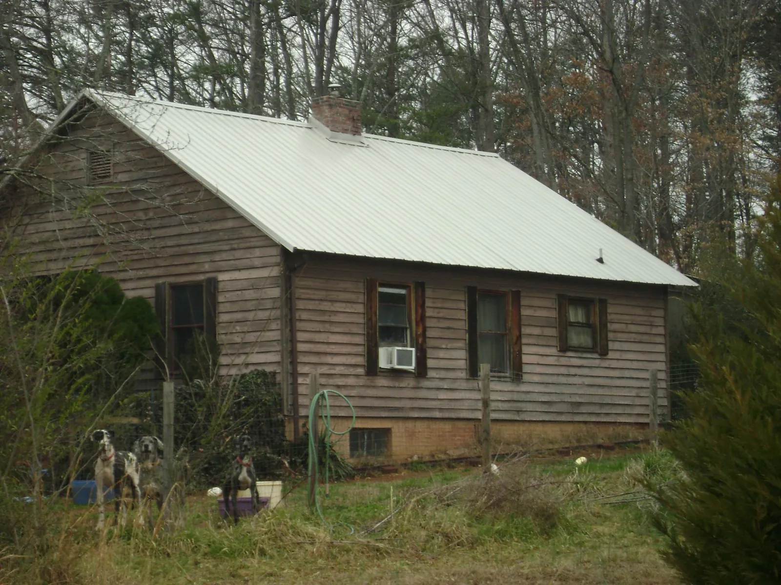 White metal roof on an old wood sided farmhouse, from a Metal Roof Installation job in Apison